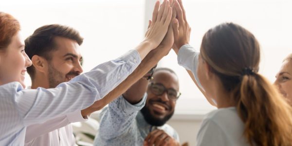 Multiracial associate business people group teammates hands give high five together promising unity as dream team concept, corporate success, teambuilding and loyalty, support in teamwork, coaching